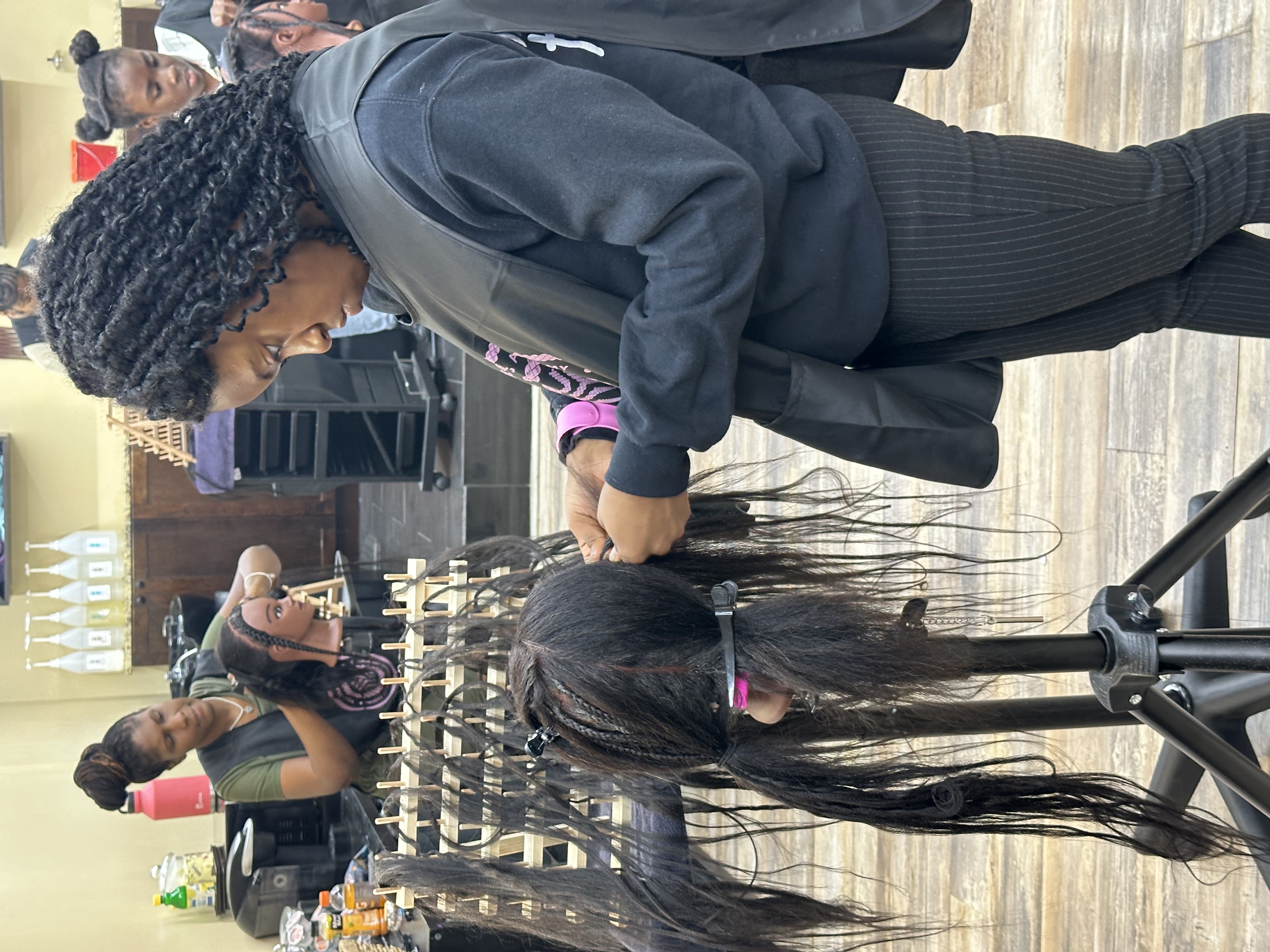 Student practicing braiding on mannequin