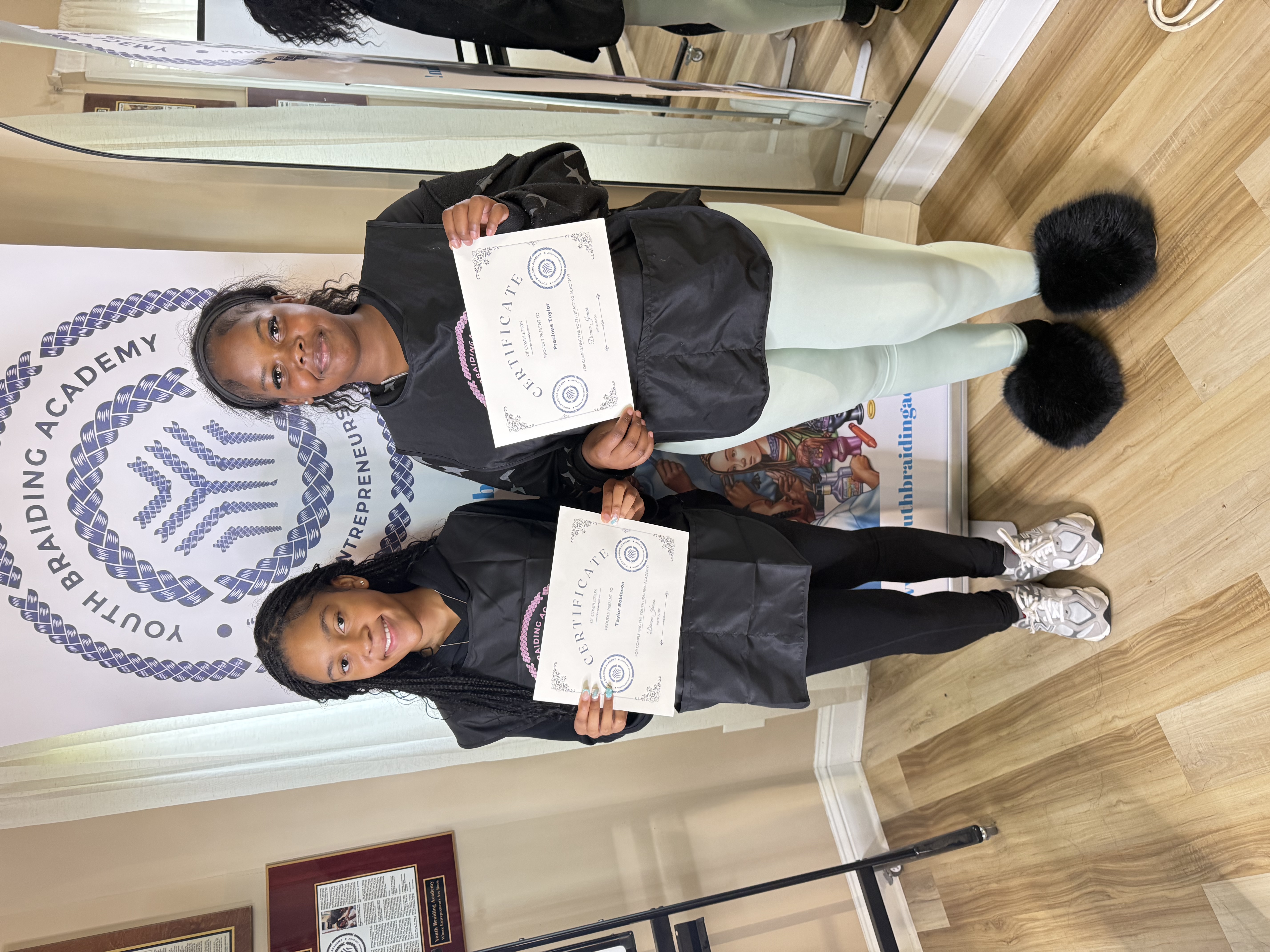 Students holding certificates of completion